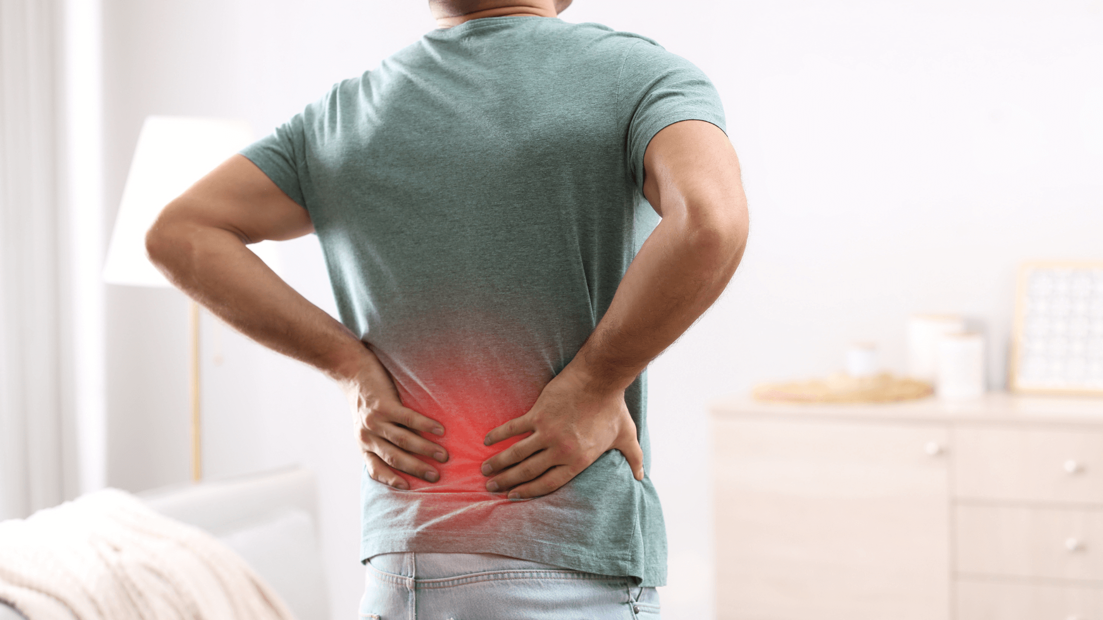 A man holding his lower back, with a red glow highlighting the area of pain, illustrating the need to seek medical attention for persistent back pain.