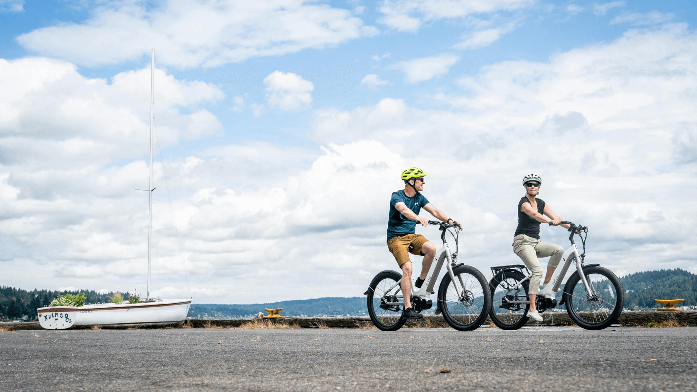 Two individuals enjoy a bike ride outdoors, symbolizing an active lifestyle and improved mobility potentially achieved through regenerative medicine and effective pain management.