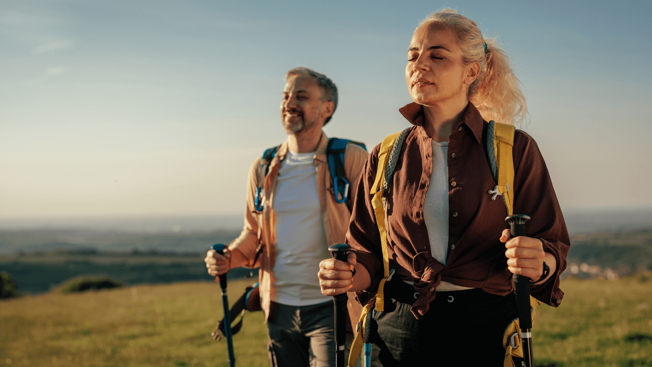 A fit couple enjoying a scenic hike, representing an active, pain-free lifestyle restored by advanced treatments like regenerative medicine and stem cell therapy, potentially helping them avoid back surgery.
