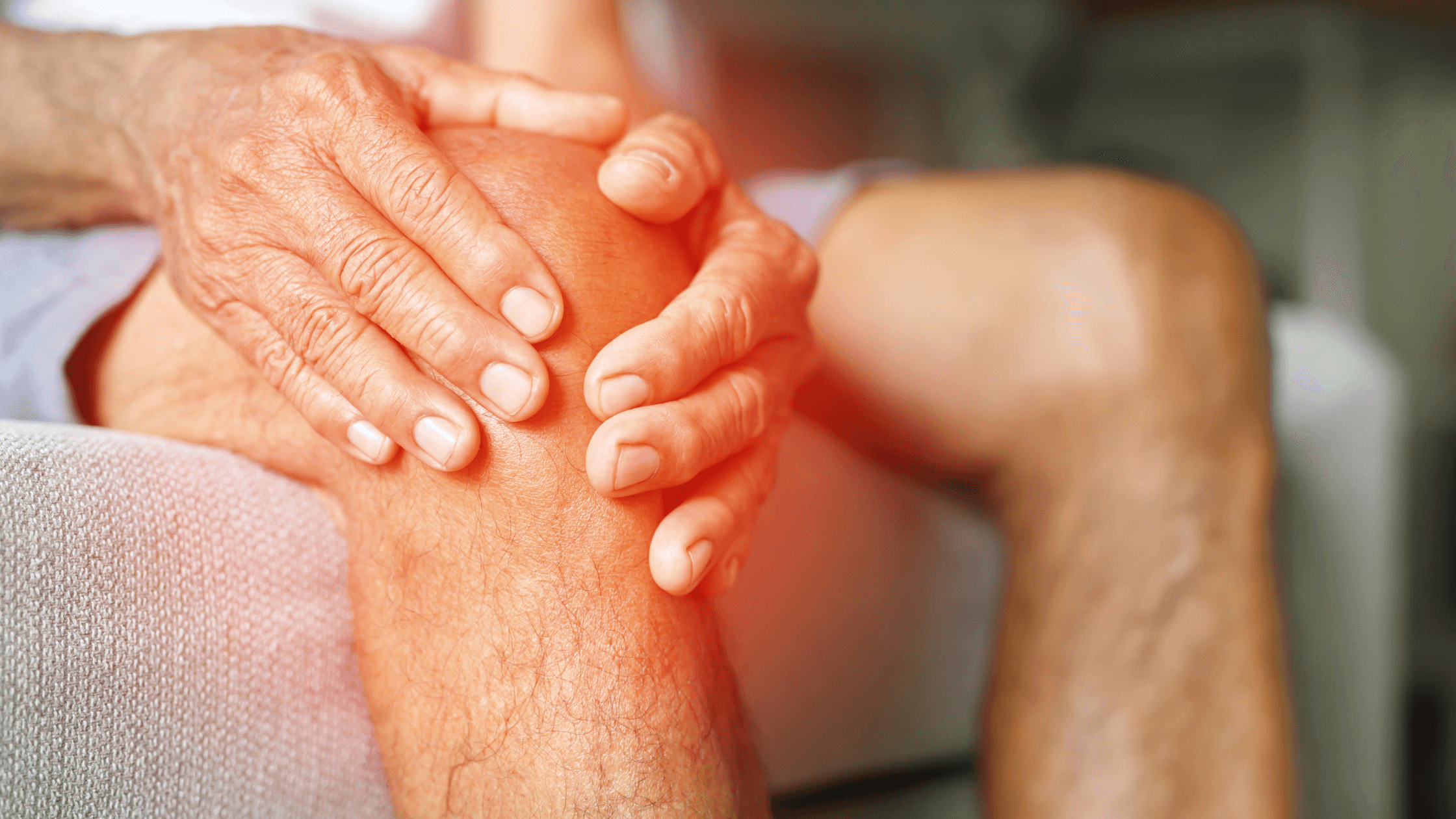 A person grips their knee in pain, with a red glow indicating the affected area, illustrating the discomfort of knee and hip pain that regenerative medicine treatments like PRP therapy aim to relieve.